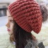 flat knit beret with fur pom on mannequin - side view