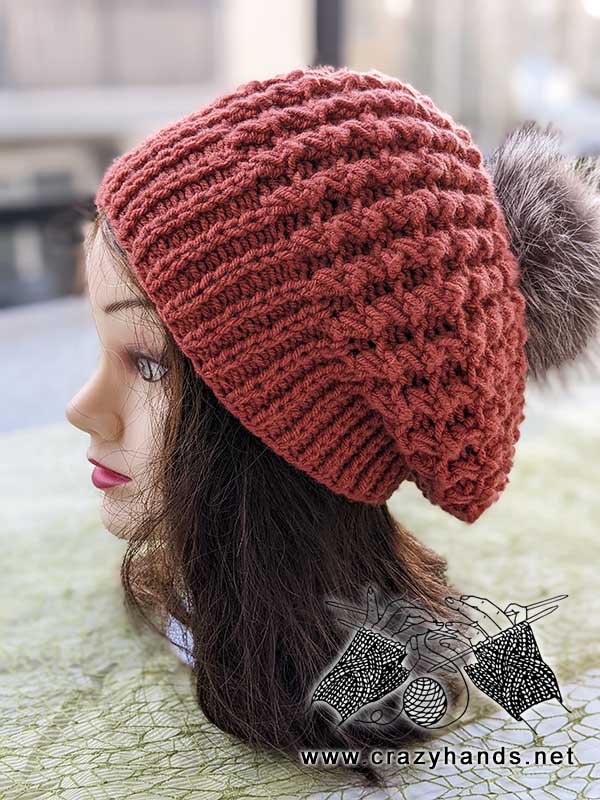 flat knit beret with fur pom on mannequin - side view
