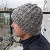 unisex winter knit hat on the male model - left side view