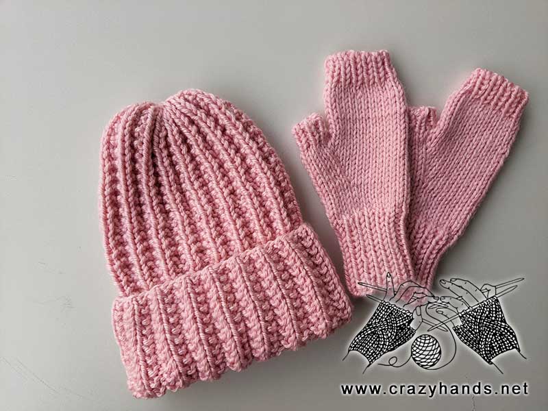 bulky ribbed knit hat and fingerless gloves made with pink yarn