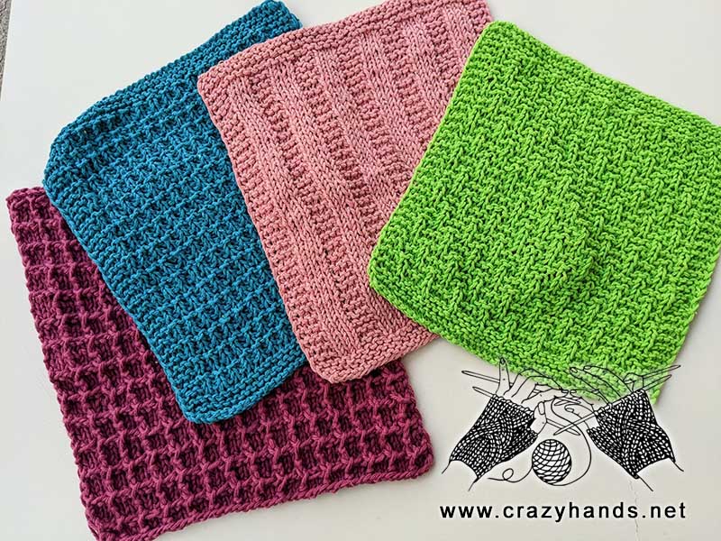 four knit kitchen towels made using various patterns and yarn colors