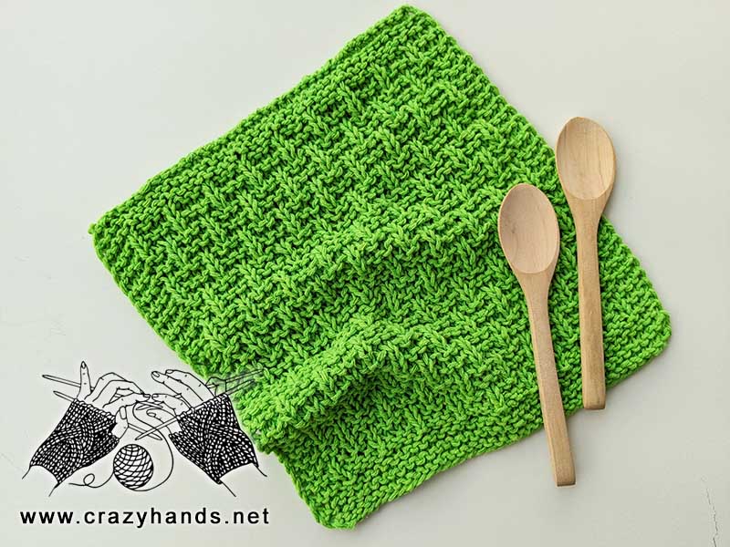 rebar knit kitchen towel with two wooden spoons
