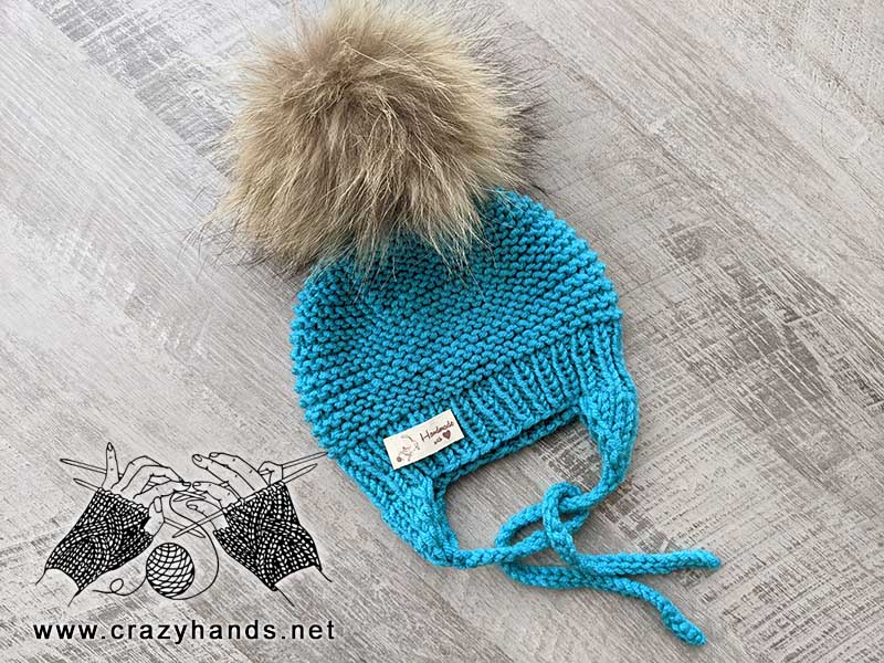 knit baby hat with round crown and earflaps
