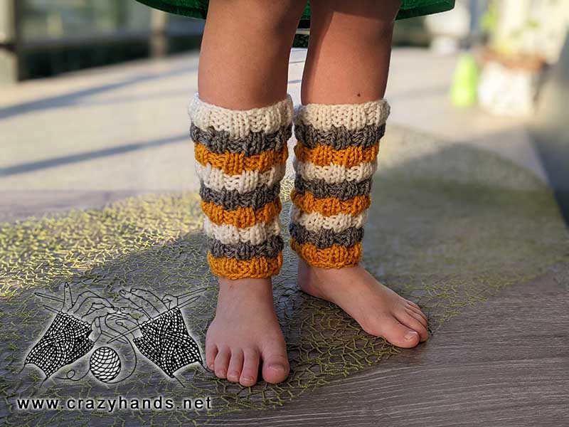 baby knit leg warmers on a baby model - front view