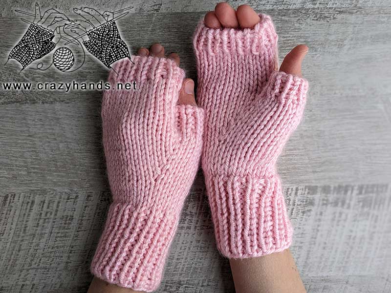 bulky knit fingerless gloves in pastel pink color