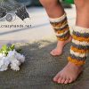 three-color baby knit leg warmers made with white, gray, and orange yarn