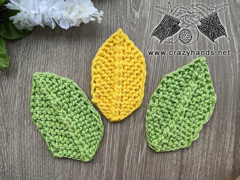 knit autumn hexagonal leaves - two green leaves on the side and the yellow one in the middle