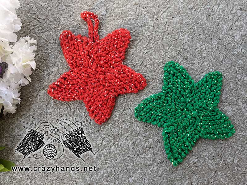 two flat five-point knit stars - one green and one red