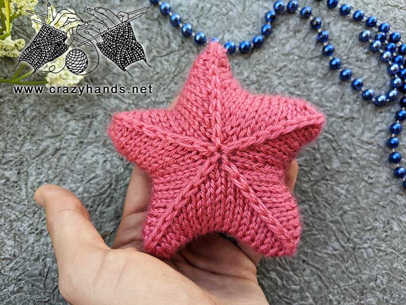 knit five point 3D star made with pink yarn
