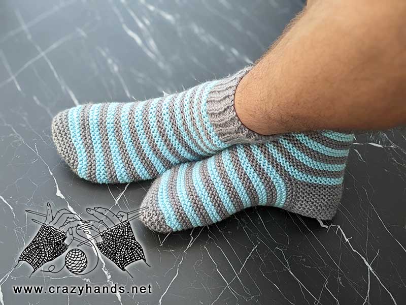 flat knit two needles two-color socks on male's feet - side view