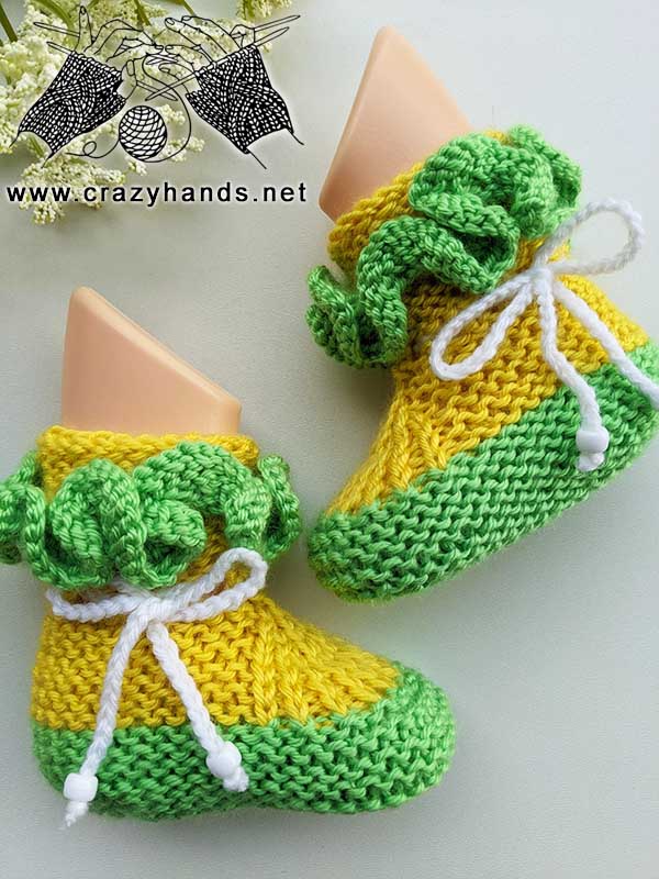 knit baby booties on the mannequin feet