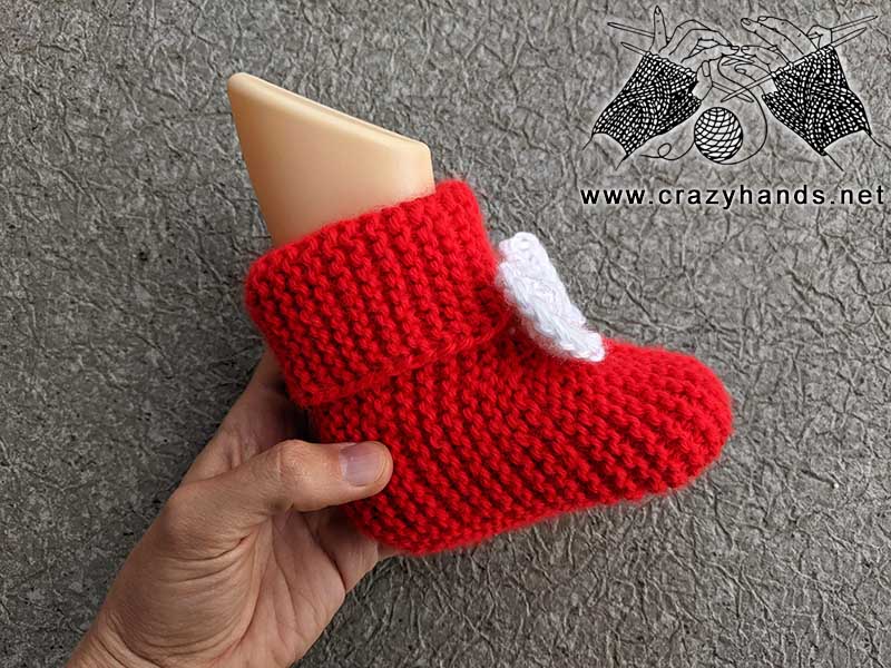 knit baby booties with decor bow