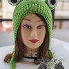 knit frog hat on a female head mannequin - front view