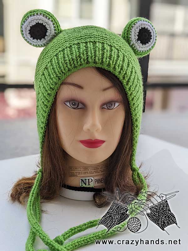 knit frog hat on a female head mannequin - front view