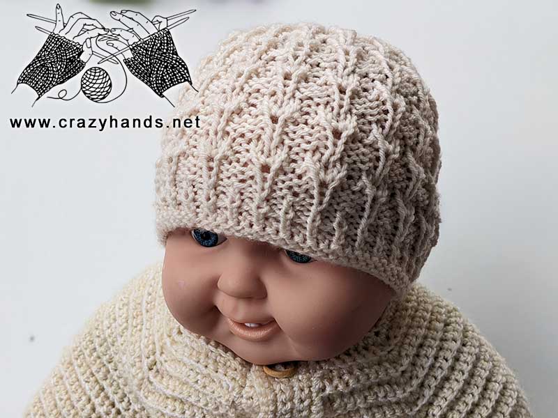 knit newborn baby hat on a doll mannequin - front view