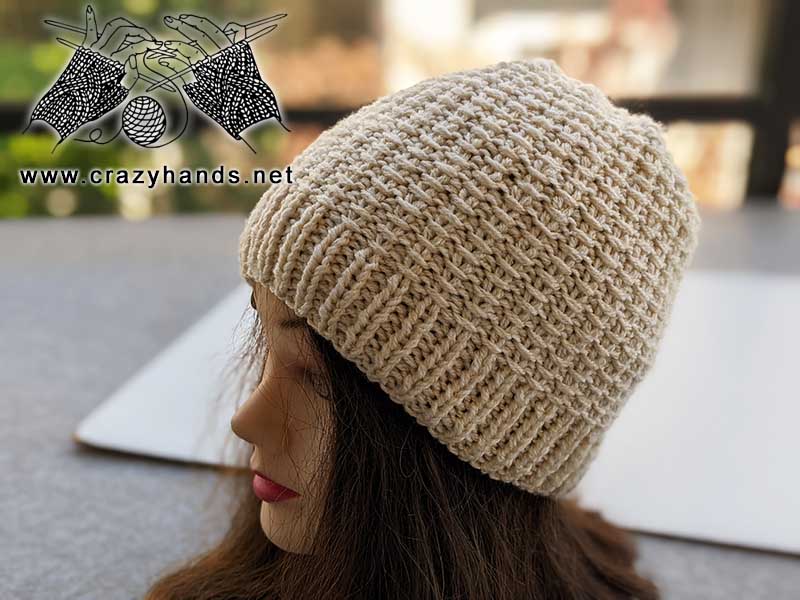 knit two-needles hat on a mannequin's head - left side view