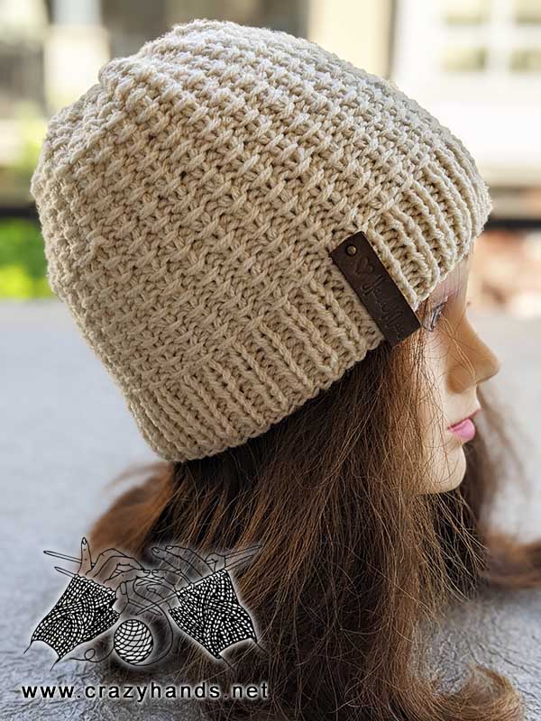 knit two-needles hat on a mannequin's head - right side view