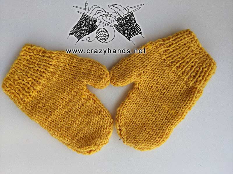 a pair of knit flat kid's mittens