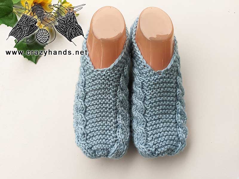 flat knit cable slippers on the mannequin feet