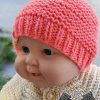 knit newborn beanie on a baby doll - front view