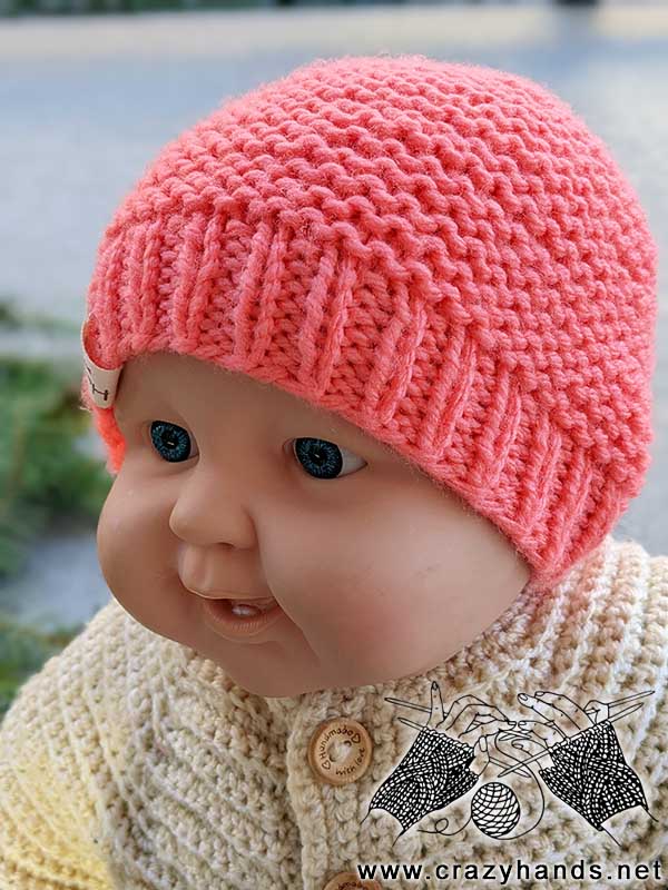 knit newborn beanie on a baby doll - front view