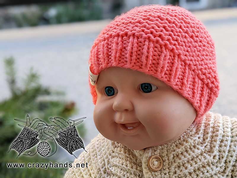 knit newborn beanie on a baby doll