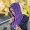 left side view of a knit ribbed hooded cowl on a female model