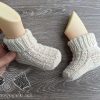 knit newborn baby socks made in round - on mannequin's feet