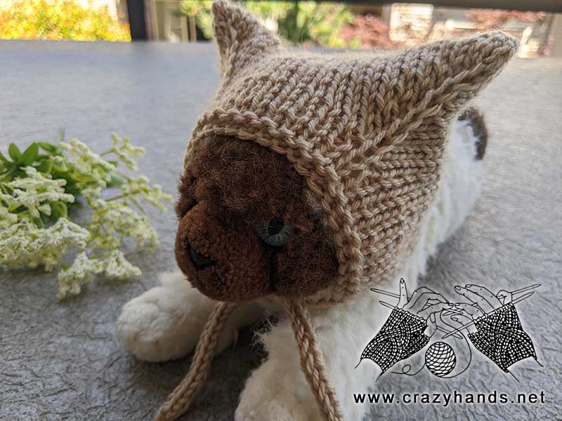 knit hat on a kitty toy - left-side view