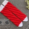 knit no-heel Santa-style spiral socks laying on the flat surface