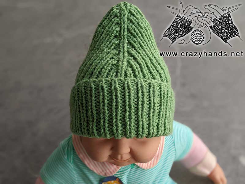 knit mountain infant hat on a baby doll - front side view