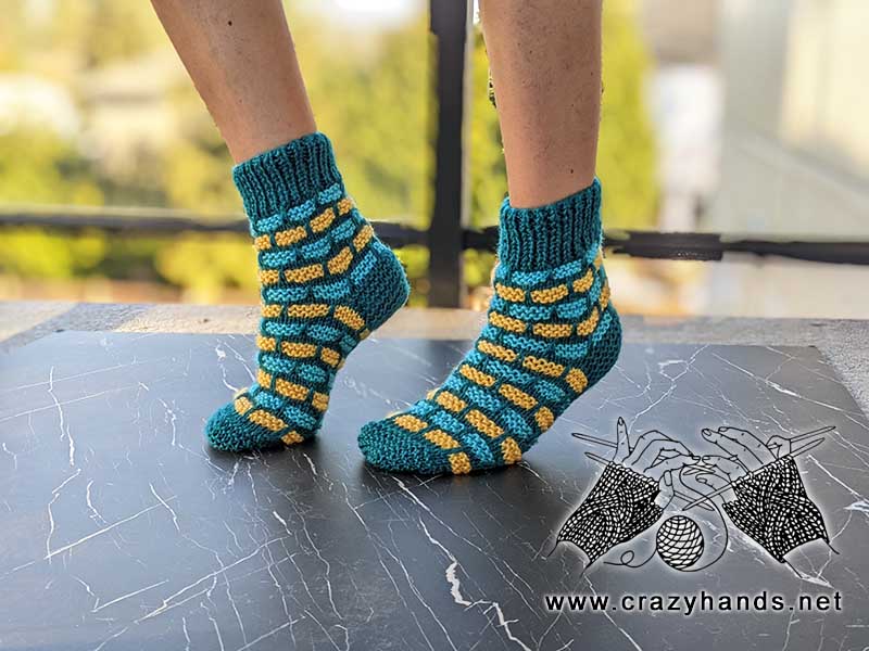 bricklane flat knit socks on the female model's feet - left side view