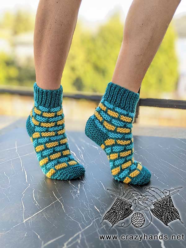 bricklane flat knit socks on the female model's feet - right side view