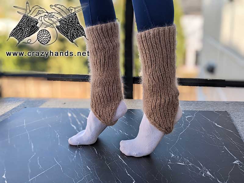 knit stirrup leg warmers on female's feet - left side view