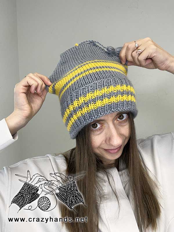 golden striped knit beanie on a female model - front-side view