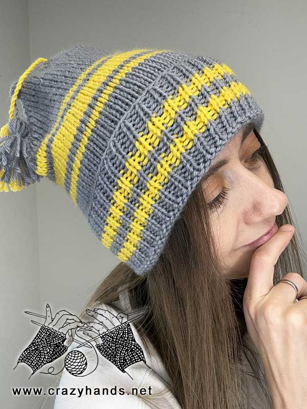 golden striped knit beanie on a female model - right-side view