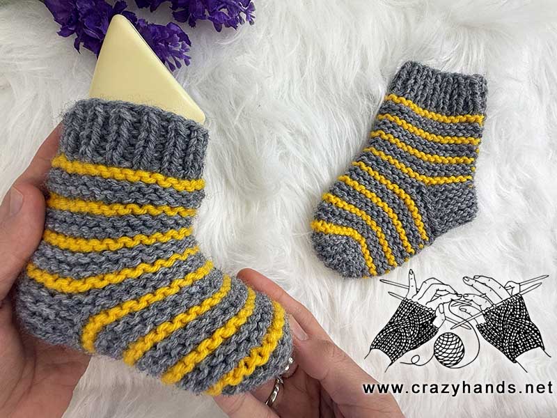 knit flat striped baby sock on baby mannequin foot