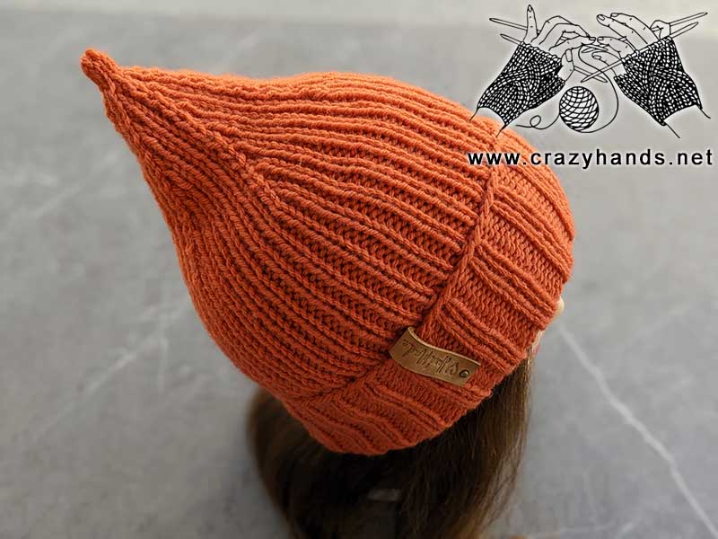 knit pumpkin hat on mannequin's head - top right side view
